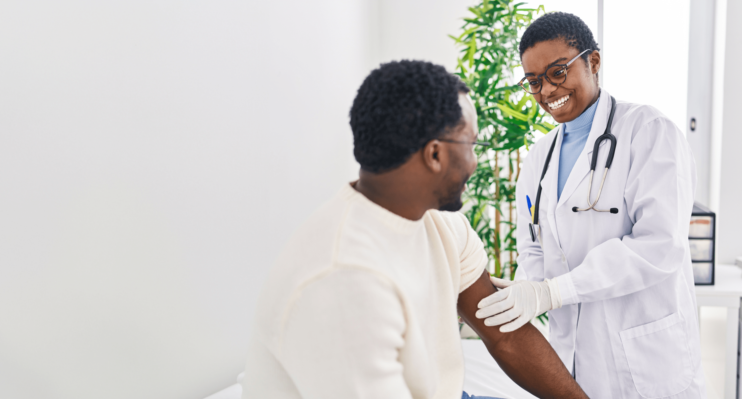 Doctor putting band aid at clinic