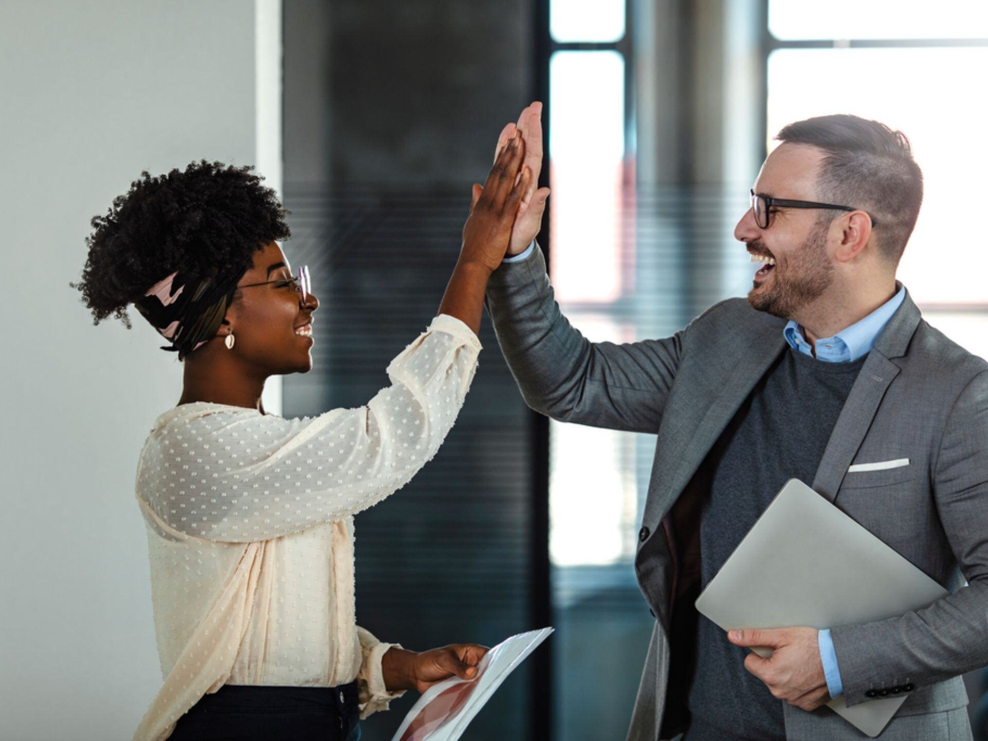 Coworkers celebrating achievement at the office