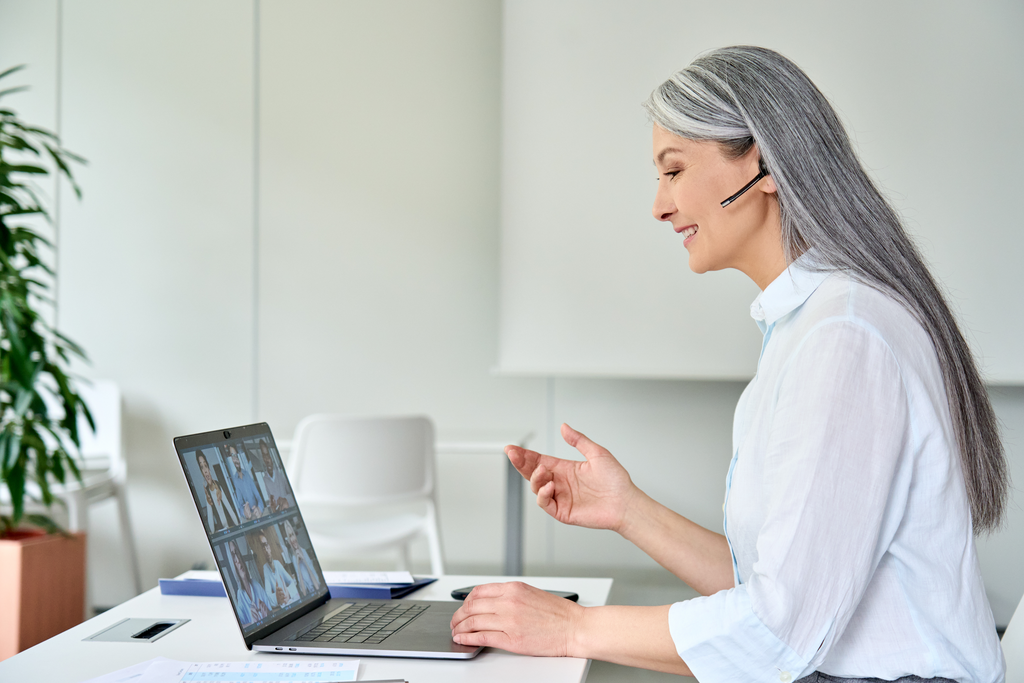 Happy smiling older Asian businesswoman