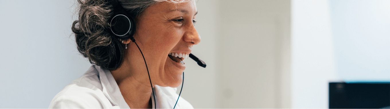 Woman in medical uniform working on computer