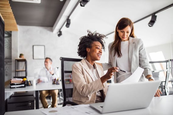 Woman showing something to another colleague